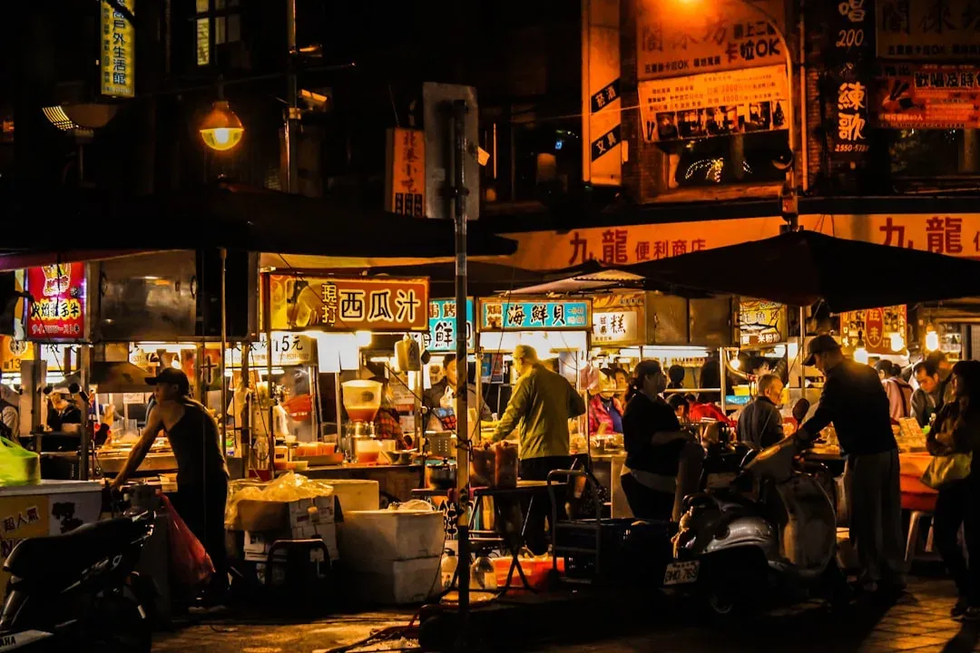colorful street food vendors serving local dishes at night